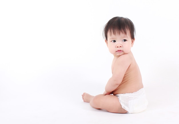 Portrait of happy little asian baby boy or girl sitting on floor