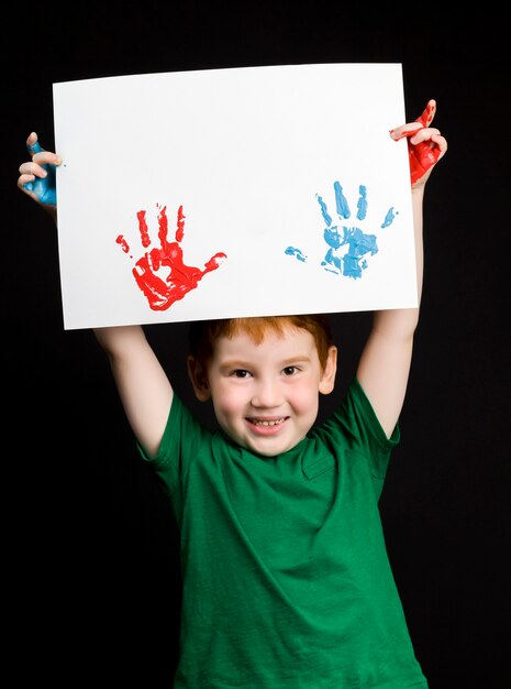 Portrait of a happy little redhaired boy