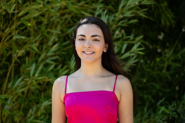 Portrait of a happy lovely and beautiful Spanish young woman in a park