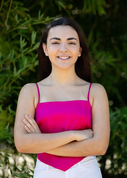 Portrait of a happy lovely and beautiful Spanish young woman in a park