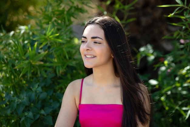 Portrait of a happy lovely and beautiful Spanish young woman in a park