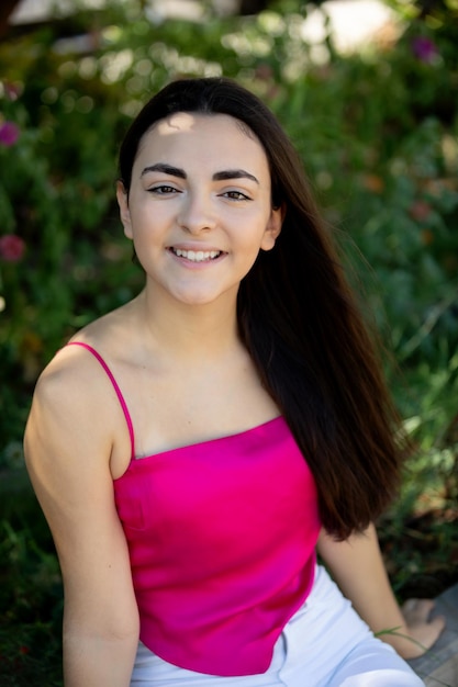 Portrait of a happy lovely and beautiful Spanish young woman in a park