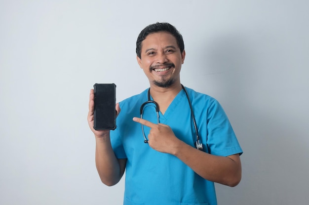 Portrait of happy male nurse showing phone screen