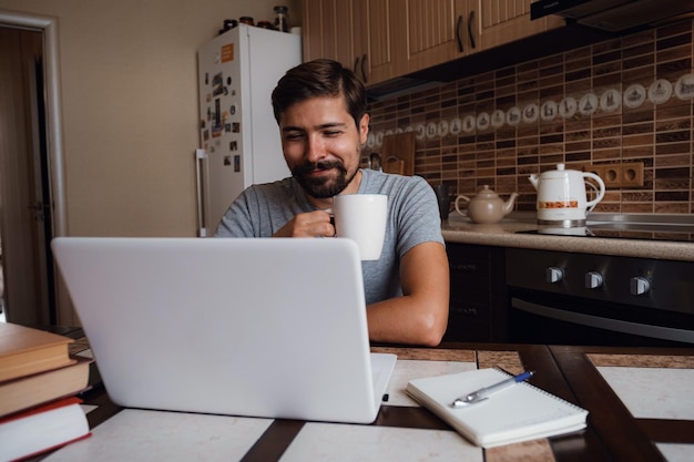 Portrait of happy man having a cup of coffee in kitchen