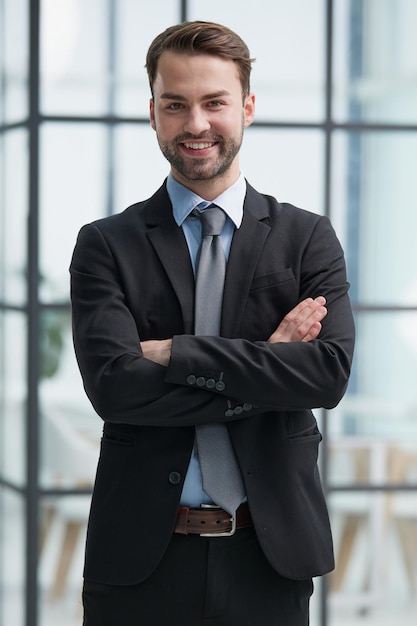 Portrait of a happy man wearing glasses and looking at the camera indoors