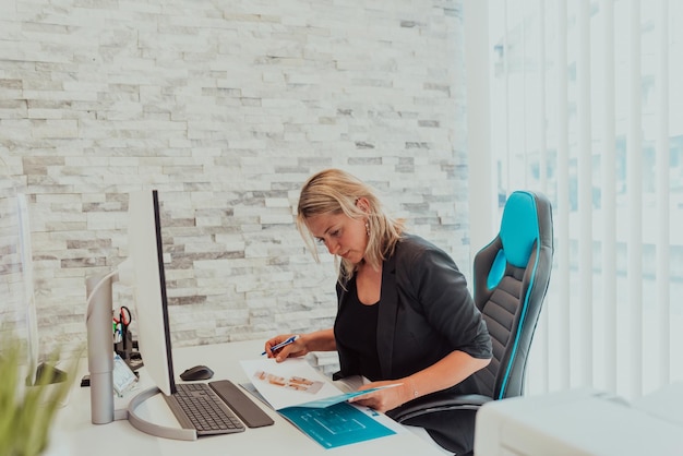 Portrait of a happy manager at bright office. Smiling at camera while sitting at office desk.High quality photo