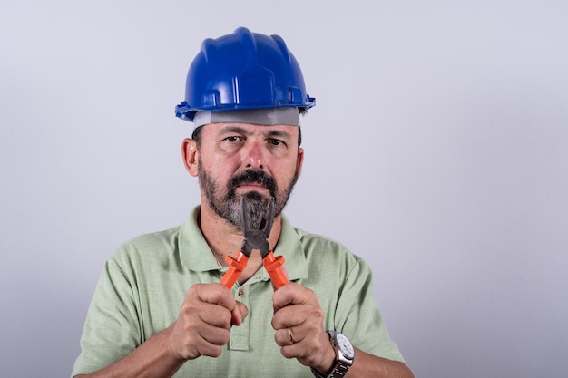 Portrait of happy mature architect in helmet standing male industrial inspector 60s wearing shirt posing in studio