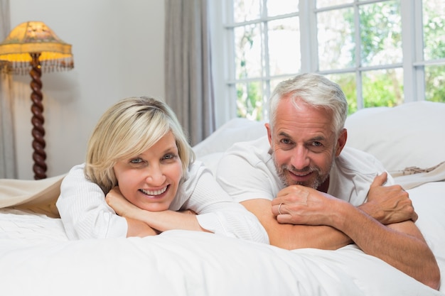 Portrait of a happy mature couple in bed