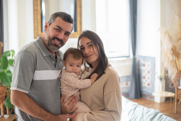 Portrait of happy mid adult Caucasian family with baby child