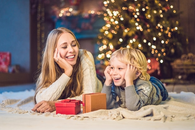 Portrait of happy mother and adorable boy celebrating Christmas. New Year's holidays