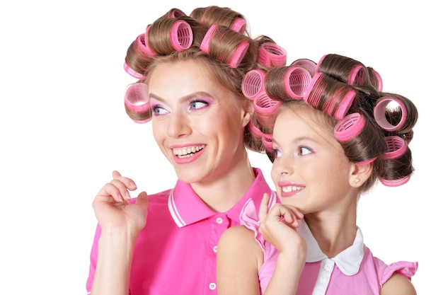 Portrait of happy  Mother and little daughter in hair curlers in studio