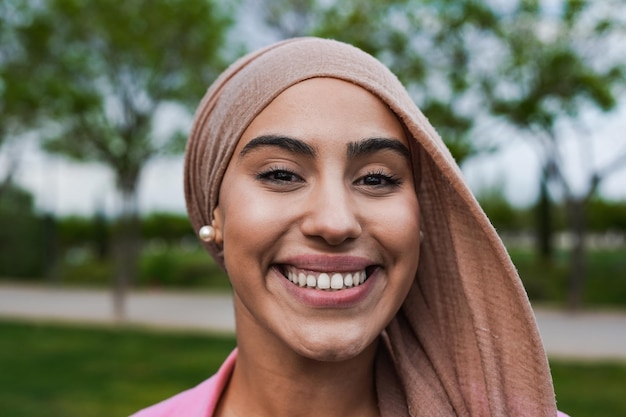 Portrait of happy muslim woman smiling on camera outdoor