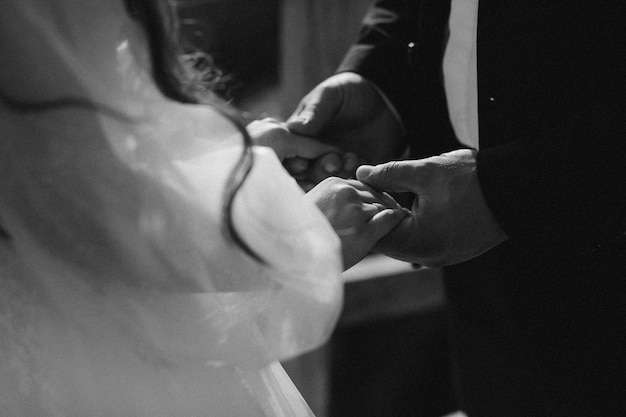 Portrait of happy newlyweds hugging, smiling and looking at each other. Concept of wedding couple