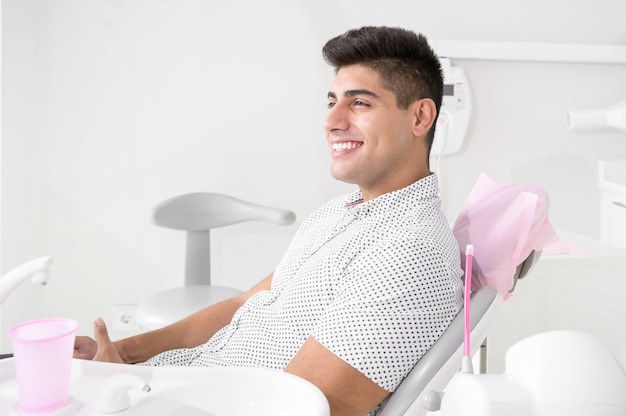 Portrait of happy patient in dental chair