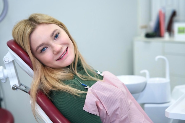 Portrait of happy positive cheerful blonde european girl young satisfied smiling woman patient with