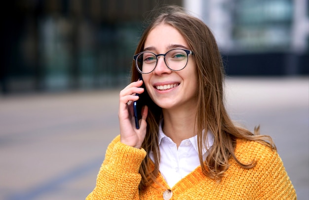 Portrait of happy positive cheerful girl young beautiful woman student in glasses is laughing