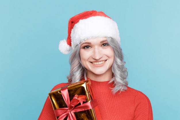 Portrait of happy santa woman hugs gift box isolated