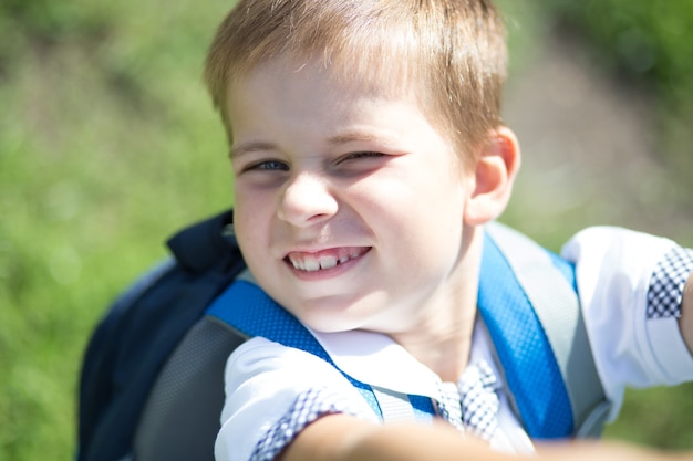 portrait of happy school kid is going to school for the first time