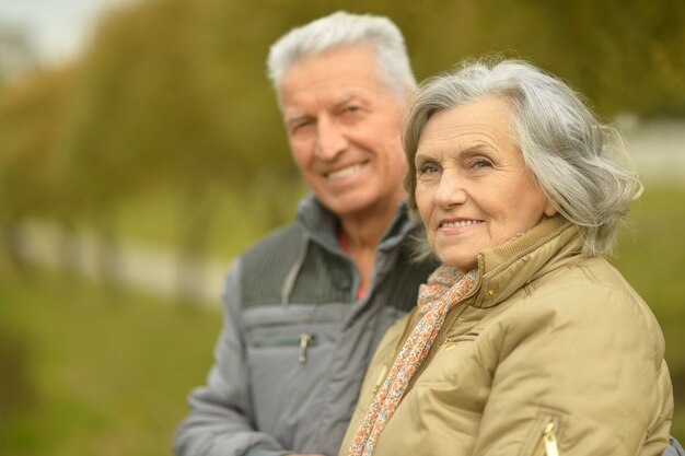 Portrait of a happy senior couple in autumn park