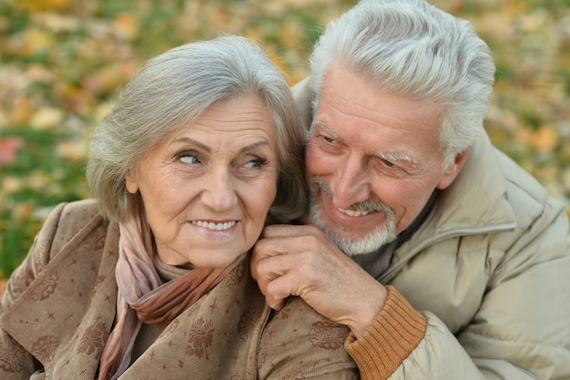 Portrait of a happy senior couple in autumn park