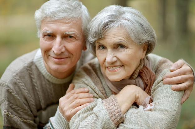 Portrait of a happy senior couple in autumn park