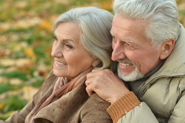 Portrait of a happy senior couple in autumn park