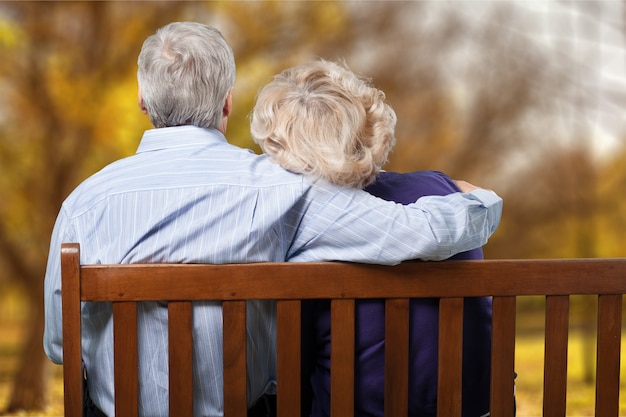 Portrait of happy senior couple on bench