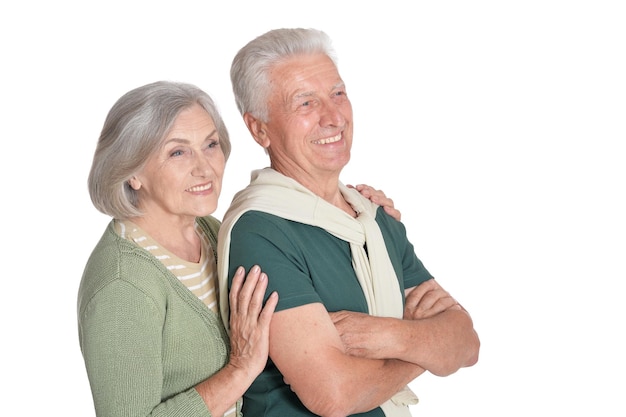 Portrait of happy senior couple embracing on white background