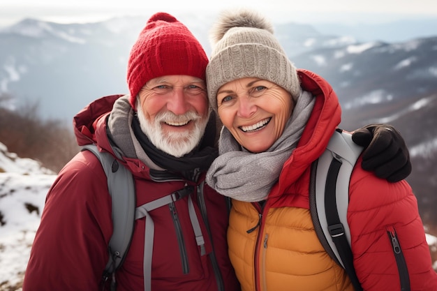 Portrait of a happy senior couple looking at camera in winter mountains Sunny cold day