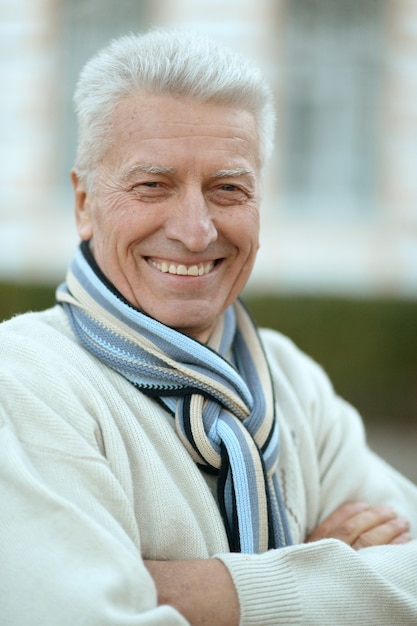 Portrait of happy senior man outdoors close-up