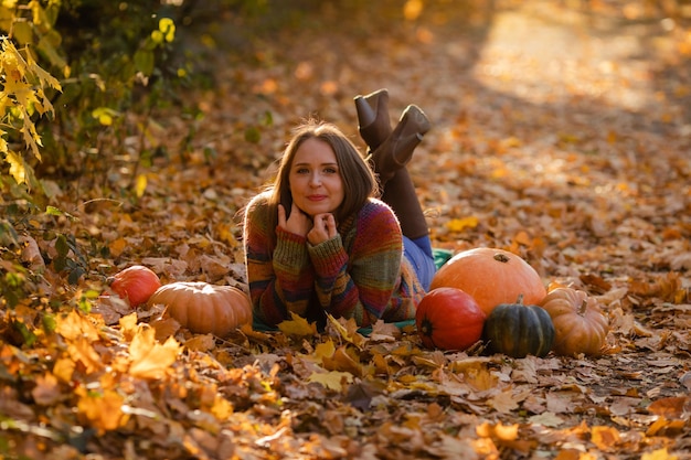 Portrait of happy smile woman with pumpkins in hand