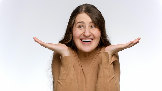 Portrait of happy smiling amazed woman against white studio background