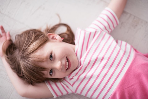 portrait of happy smiling child at home while playing