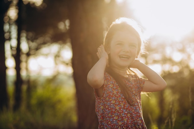 Portrait of happy smiling cute little girl child outdoors in summer day