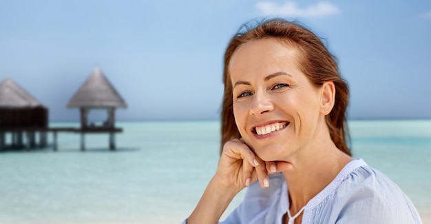 portrait of happy smiling woman on summer beach