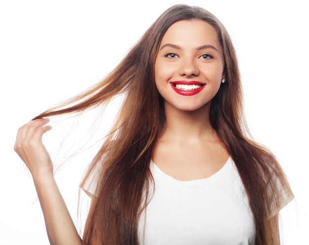 Portrait of happy smiling young beautiful woman isolated over white background