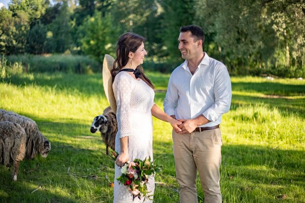 Portrait of a happy wedding couple on their wedding day Beautiful newlyweds are dancing on a wedding walk on a warm autumn day Newlyweds at sunset in city park