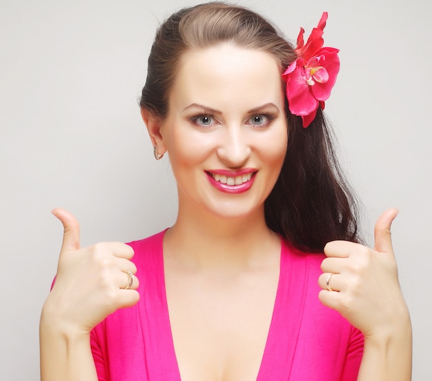 Portrait of happy woman showing thumbs up