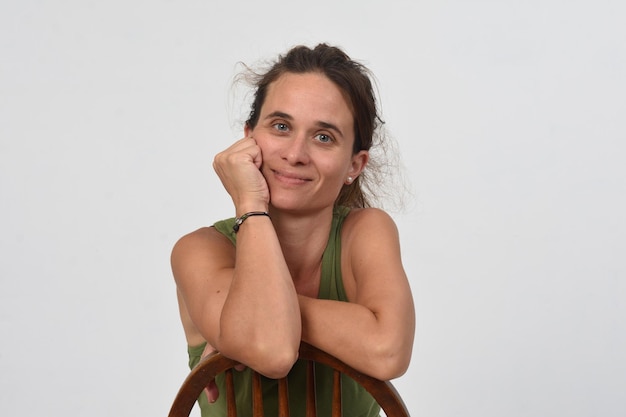 Portrait of a happy woman sitting on chair and looking at camera