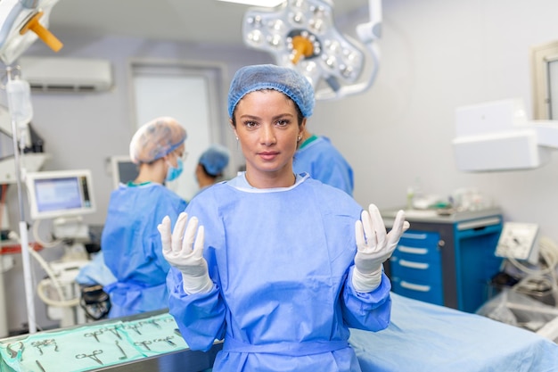 Portrait of happy woman surgeon standing in operating room ready to work on a patient Female medical worker in surgical uniform in operation theater