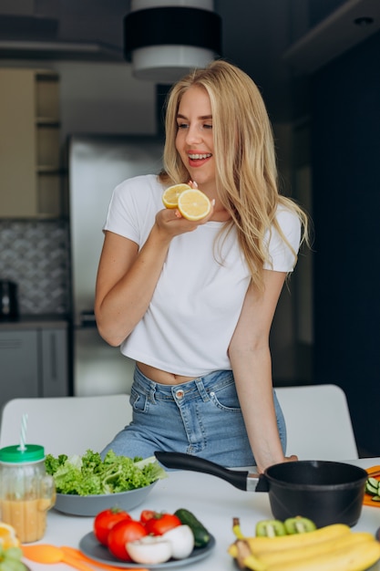 Portrait of happy woman at the table with a healthy food. 