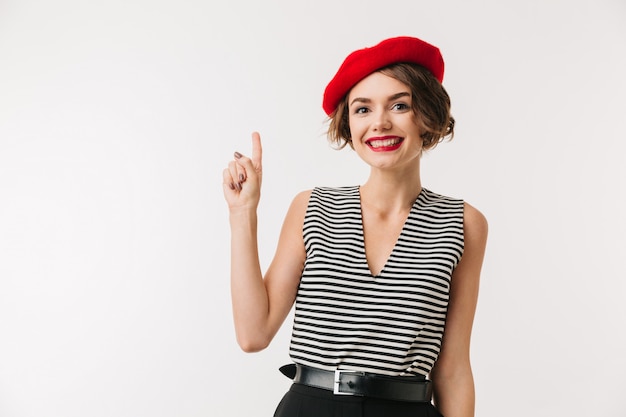 Photo portrait of a happy woman wearing red beret pointing