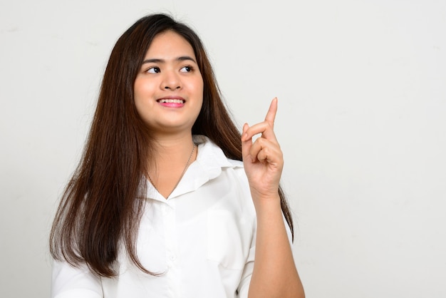 Portrait of happy young beautiful Asian woman