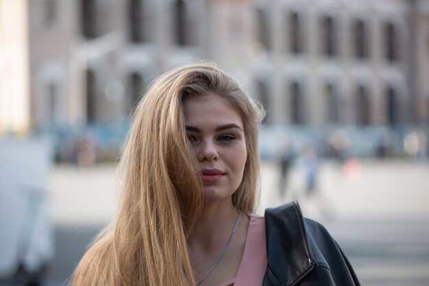 Portrait of happy young blonde woman in sunglasses with long hair