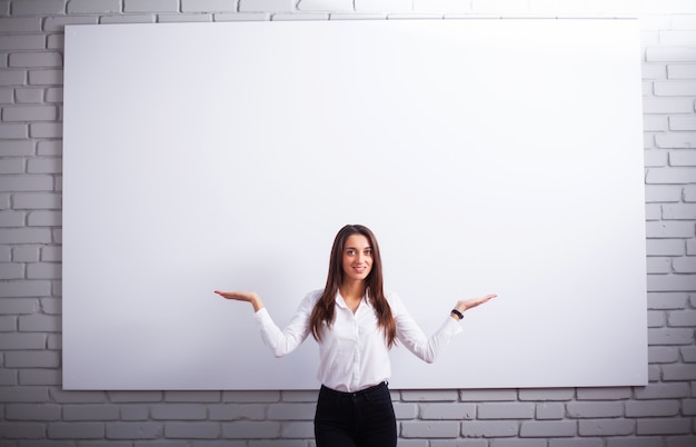 Portrait Of Happy Young Businesswoman woman near on white wall.