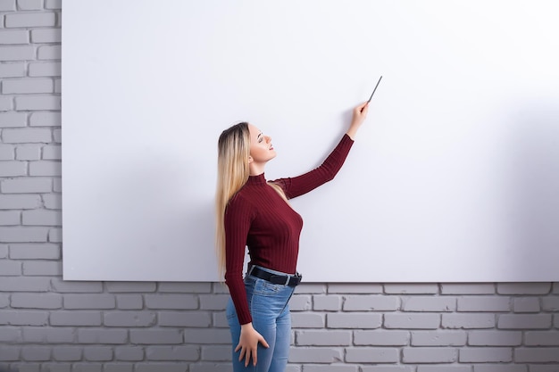 Portrait Of Happy Young Businesswoman woman near on white wall