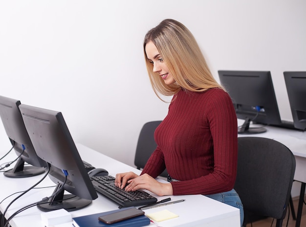 Portrait of happy young businesswoman woman near on white wall