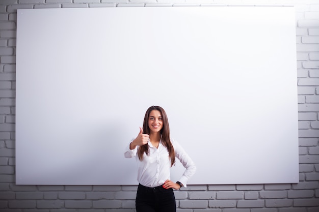 Portrait Of Happy Young Businesswoman woman near on white wall