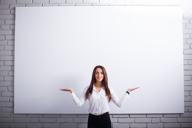 Portrait Of Happy Young Businesswoman woman near on white wall.