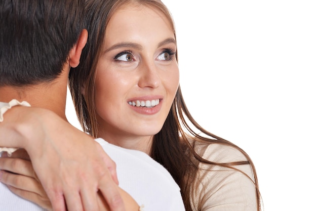 Portrait of happy young couple posing on white background